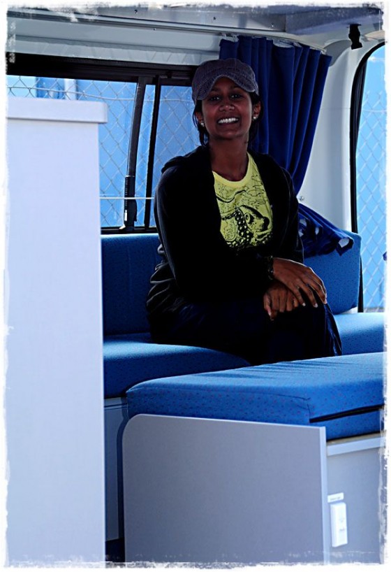 Manali Sitting In Britz Campervan - Tasmania, Australia